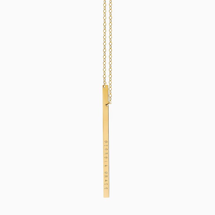 "Sleek, simple and made for everyday, our vertical bar necklace evokes effortless cool and is available in 14k gold filled or sterling silver. The long slim bar may be personalized with up to 18 characters in total, and is hung from asymmetrical points, for an off-kilter look. We create our name bars from a thick gauge metal which gives this piece a high quality look! (All designs & text copyright LUCA jewelry LLC). (Model is wearing a 24 \" long necklace, with the bar hanging a further 2.5\ Minimalist Yellow Gold Bar Necklace With Cable Chain, Minimalist Yellow Gold Bar Necklace With Rectangular Pendant, Gold Bar Necklace With Rectangular Pendant For Everyday, Minimalist 14k Gold Bar Necklace With Rectangular Pendant, Gold Minimalist Rectangular Bar Necklace, Minimalist Gold Rectangular Bar Necklace, Gold Rectangular Minimalist Bar Necklace, Rectangular Yellow Gold Bar Necklace For Everyday, 14k Gold Rectangular Pendant Bar Necklace