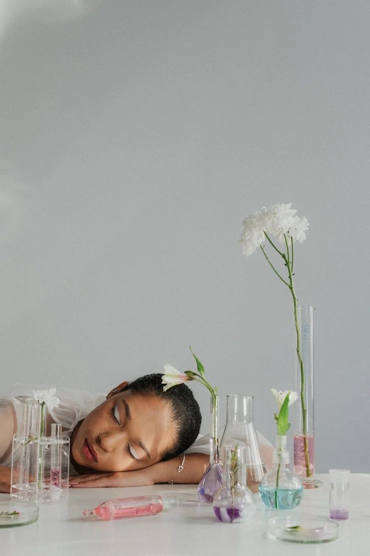 Woman Sleeping on White Table Top among Flasks with Flowers · Free Stock Photo Woman Resting, Woman Sleeping, Diy Haircare, Healthy Hair Routine, Brown Adipose Tissue, Homemade Shampoo, Happy New Year Images, Adipose Tissue, New Year Images