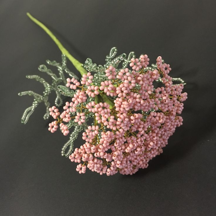 a bunch of pink flowers sitting on top of a black table next to each other