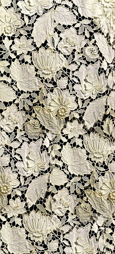 white flowers on black and white lace with an intricate design in the center is shown