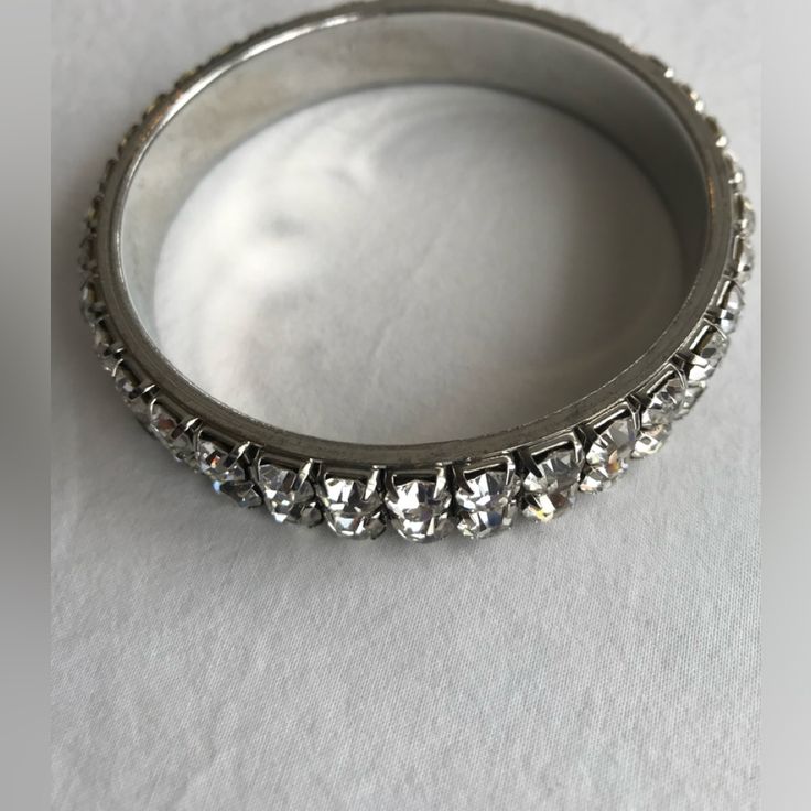 This Stunning Silver Tone Rhinestone Bangle Bracelet Features A Double Row Of 6mm Prong Set Rhinestones. This Is A Nice, Heavy Piece! The Inner Diameter Is 2 3/4" Which Will Fit An 8" Wrist. The Bangle Is 1/2" Wide. Unsigned. This Bracelet Has Been Meticulously Cared For And Is In Excellent Pre-Owned Condition. Please See Photos For Details. Vintage Condition: Slight Signs Of Wear Are Considered Typical For Authentic Vintage Pieces, Such As Light Surface Scratches Or Natural Patina. This Type Of Normal Wear Attests To An Item's Age And Adds To Its Vintage Charm & Character! Please See Photos For Details. Smoke-Free. Same Or Next Business Day Shipping! Thi Silver Crystal Bracelet With Rhinestones, Silver Crystal Bracelet With Bling And Adjustable Fit, Silver Crystal Bracelet With Diamond Accents, Glamorous Silver Crystal Bracelet With Rhinestones, Glamorous Silver Crystal Bracelets, Silver Sparkling Adjustable Crystal Bracelet, Adjustable Dazzling Silver Crystal Bracelet, Silver Sparkling Crystal Bangle Bracelet, Adjustable Silver Bling Bracelets