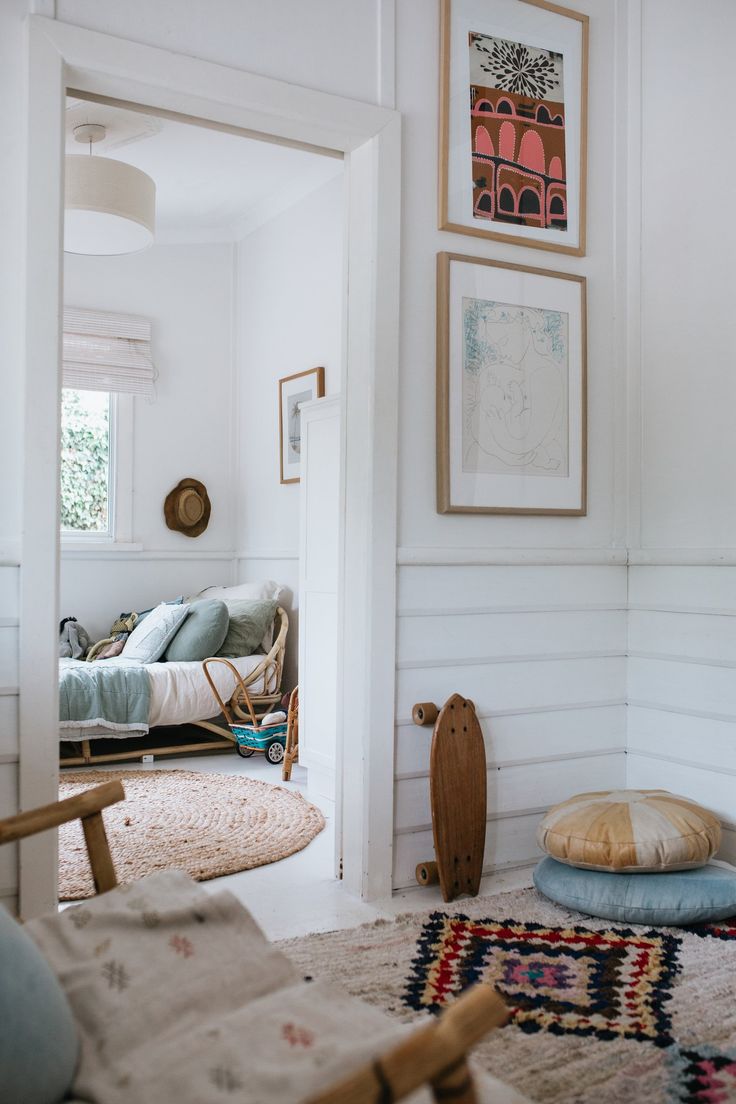 a living room filled with furniture and pictures on the wall