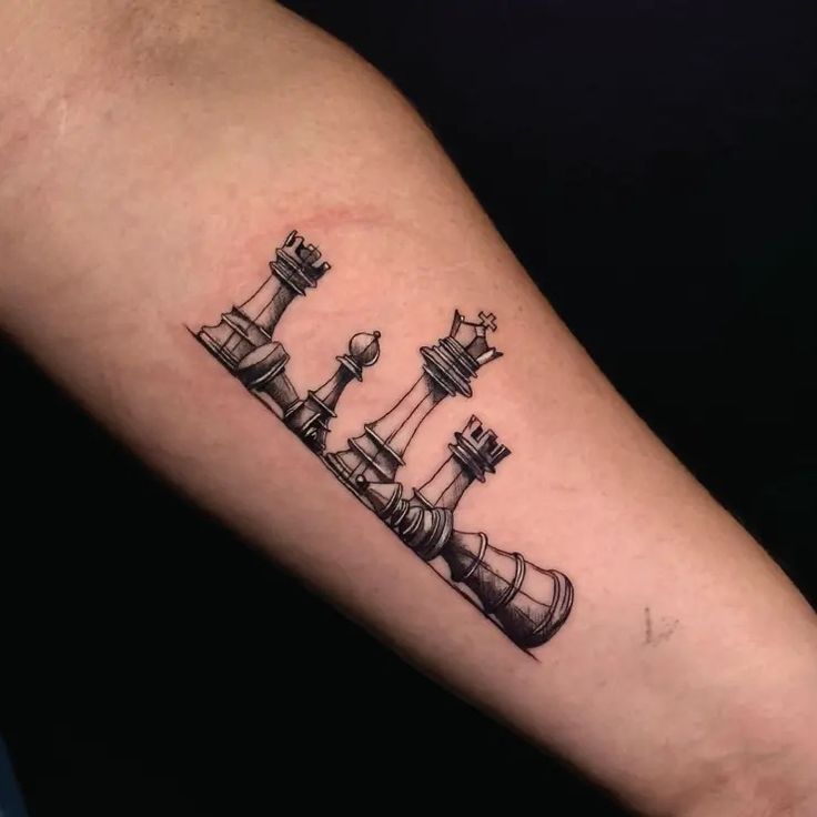 a tattoo with chess pieces on the arm