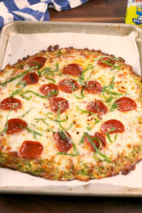 a pizza sitting on top of a pan covered in cheese and pepperoni toppings