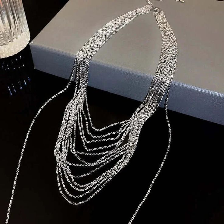 ✦ Transform your wardrobe with this Multistrand Silver Tassel Chain Necklace. Accessorize with this elegant yet simple piece for a bold and daring look. Perfect for a night out, this necklace will take your outfit to the next level. Despite the absence of diamonds, this eye-catching piece will make you shine at any party! ----------- DETAILS ----------- - Color: Silver - Materials: Brass - Necklace Length: 42.3cm - SKU: HN2699 Trendy Lariat Choker Necklace For Party, Choker Chain Jewelry For Night Out, Elegant Silver Chain Necklace For Fashion, Elegant Double Chain Necklace For Party, Metal Choker Drop Necklace For Party, Metal Drop Choker Necklace For Party, Metal Drop Necklace For Party, Trendy Silver Chain Lariat Necklace, Trendy Silver Lariat Necklace For Party