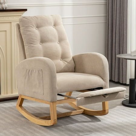 a beige rocking chair sitting on top of a hard wood floor