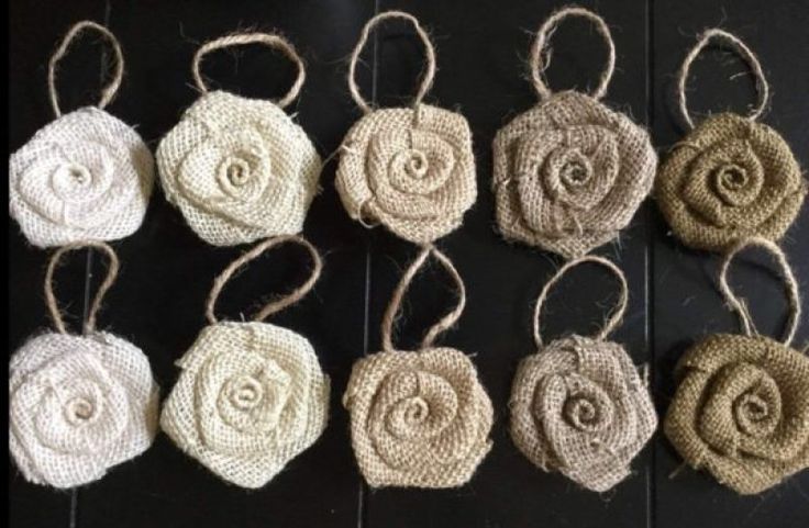 six pieces of burlocked fabric hanging from twine with flowers on them