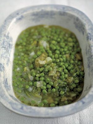 a bowl filled with green peas on top of a table