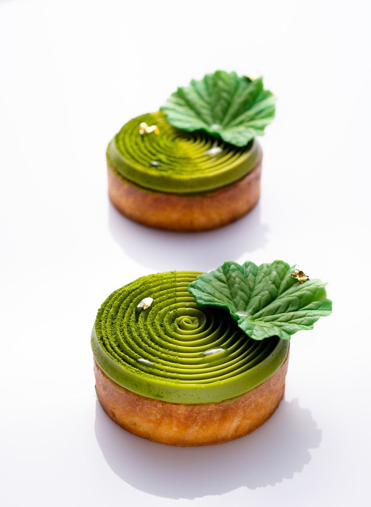 two pastries with green leaves on them