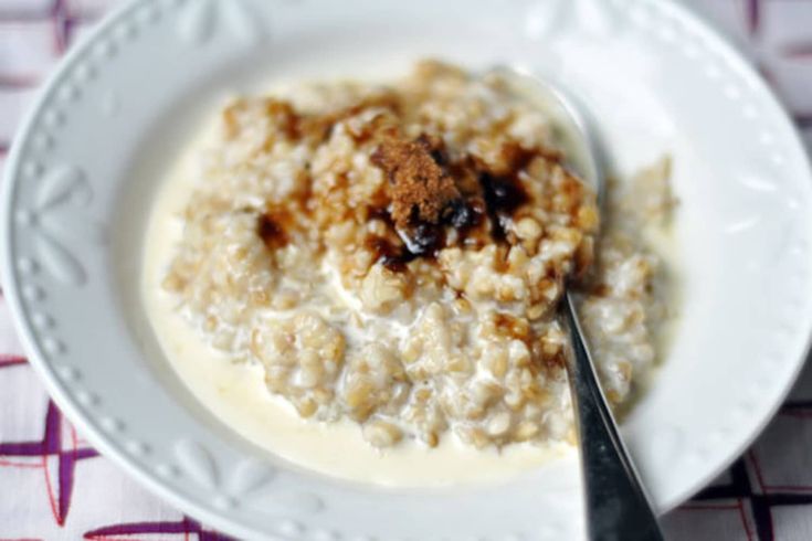 a white plate topped with oatmeal and raisins