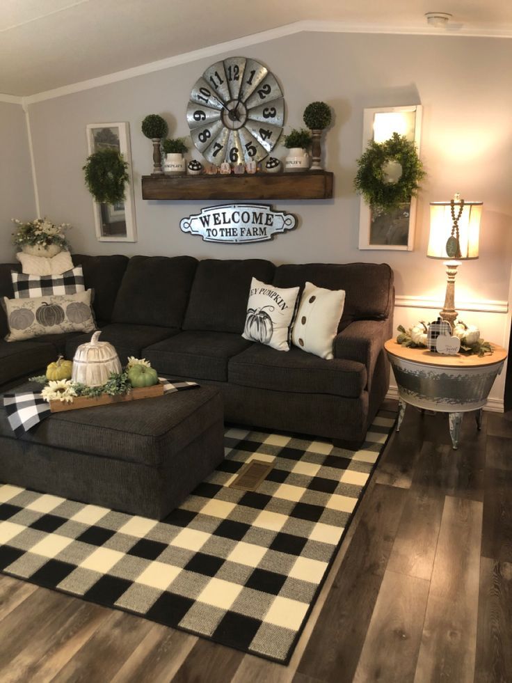 a living room filled with furniture and decor on top of a hard wood floored floor