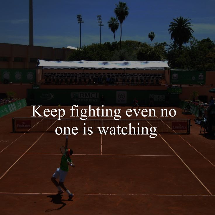 a man standing on top of a tennis court holding a racquet