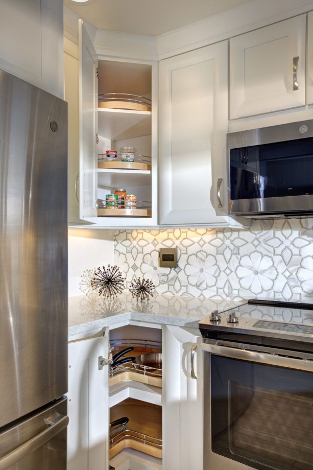 a kitchen with stainless steel appliances and white cabinets