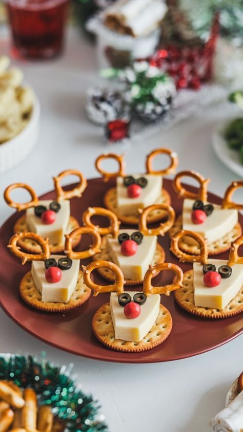 some crackers with cheese and pretzels in the shape of reindeers on them