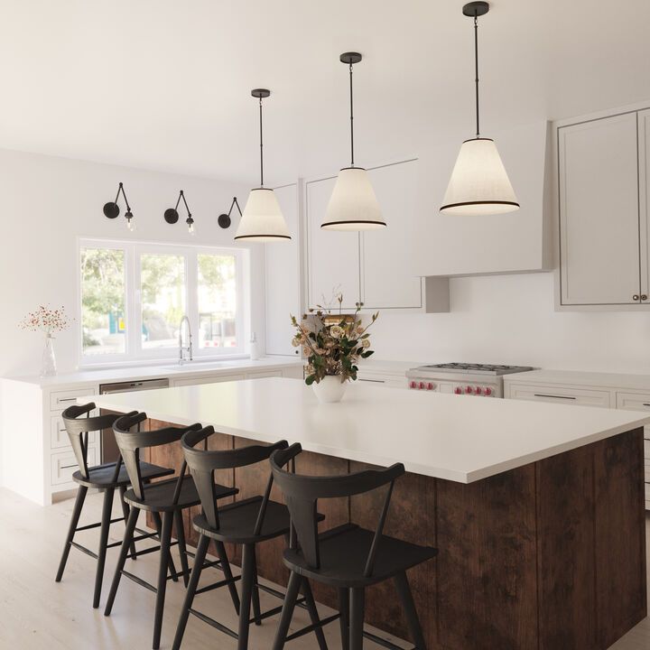 a large kitchen with an island and bar stools