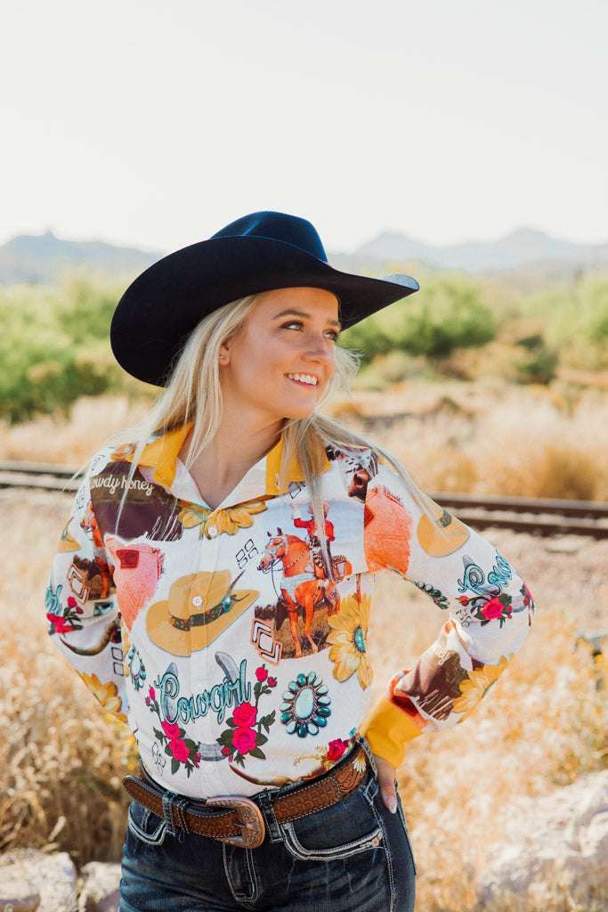 Yellow may have been considered an unlucky color in the past, but nowadays it's taking the rodeo world by storm. Let your style shine brighter than the sun with our I Need Sunshine & Fast Horses Button Down! This fashionable shirt—with its bright, colorful floral pattern and subtle tooled leather background—will make you the envy of the rodeo! We recommend pairing it with our Sunflower Tack Collection for the picture perfect hat to hoof look. Why are our TGC button downs a must have? Not only ar Western Style Shirt For Rodeo In Spring, Spring Western Shirt For Ranch, Country Style Shirt For Summer Rodeo, Western Shirt For Spring Ranch Occasions, Western Style Shirt For Ranch In Spring, Western Shirt For Country Events In Spring, Summer Long Sleeve Tops For Rodeo, Western Style Shirt For Spring Ranch, Western Style Shirt For Country Events In Spring