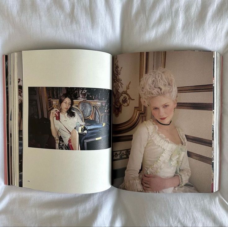 an open book with pictures of two women in white dresses and one is holding a baby