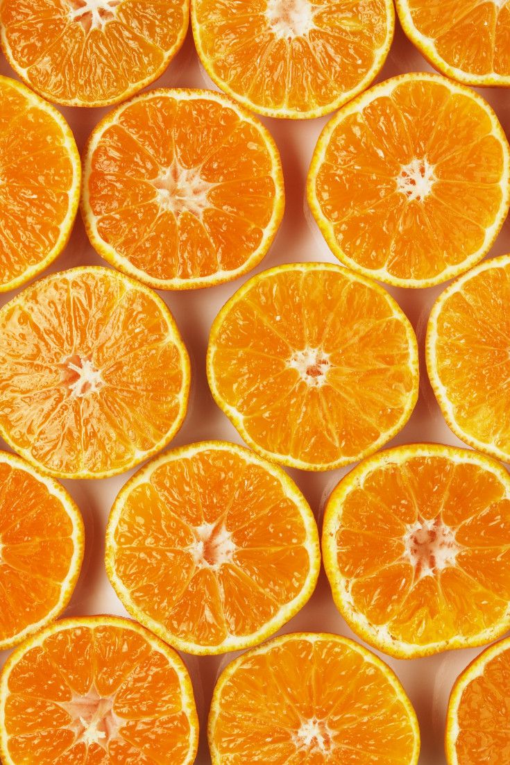 many oranges cut in half sitting on top of each other