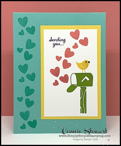 a close up of a greeting card with hearts and a bird on the mailbox