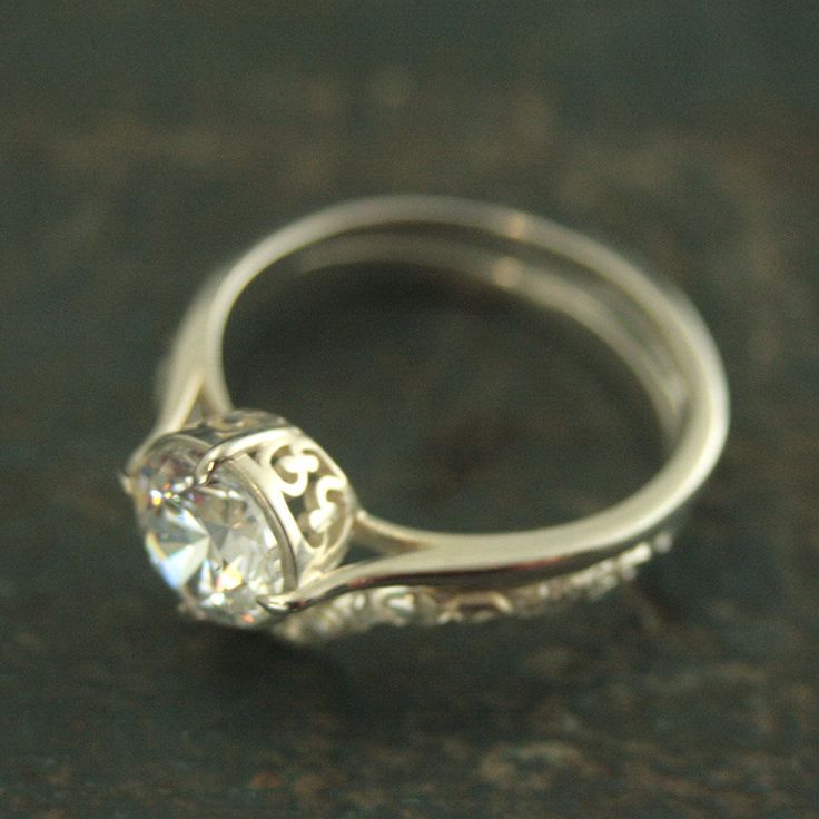 Elegant Filigree Engagement Ring and Wedding Band Sterling Silver Bridal Set Vintage Style Ring Antique Style Engagement Ring Promise Ring This is one of my favorites! I just love the North/South/East/West orientation of the delicate prongs and the vine detail along the side of the setting. Hand made from a precast solid Sterling Silver setting, your ring will be custom sized and set with a 7mm Cubic Zirconia or White Topaz. The stone sits down into the setting, protecting it. It is paired with Stackable Oval Brilliant Cut Rings For Wedding, Oval Brilliant Cut Stackable Rings For Wedding, Oval Brilliant Cut Stackable Wedding Rings, Elegant Round Band Bridal Sets For Wedding, White Gold Flower Ring With Halo Setting For Wedding, Exquisite White Gold Flower Ring For Wedding, White Gold Open Ring Jewelry For Wedding, Elegant Bridal Sets With Round Band For Wedding, Exquisite White Gold Wedding Flower Ring