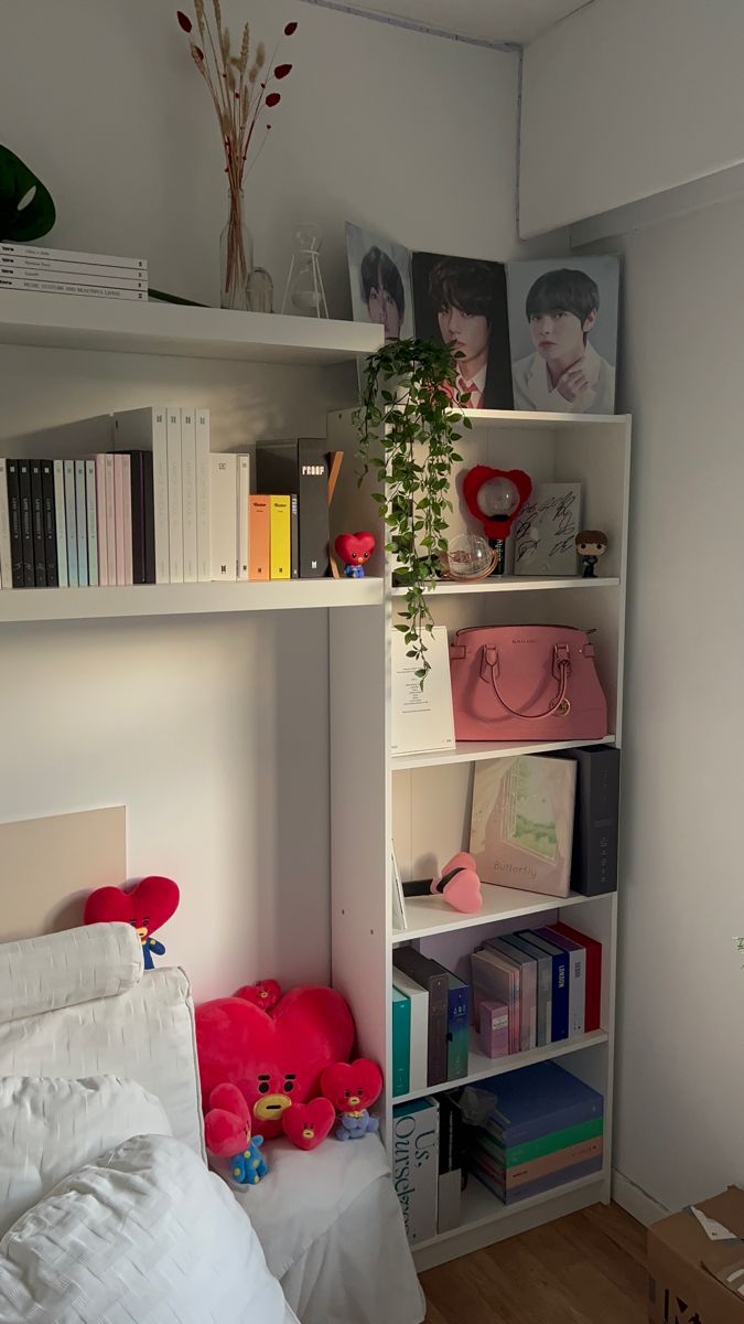 a bedroom with bookshelves and stuffed animals on the bed