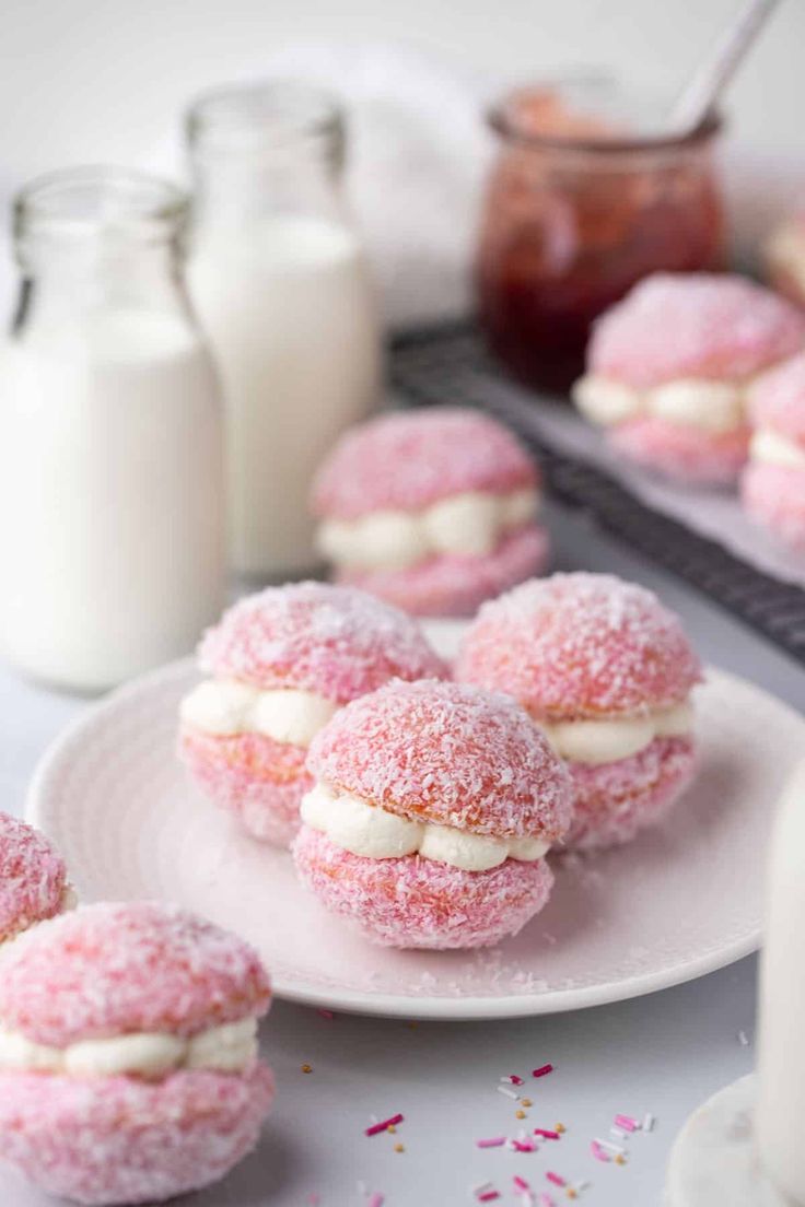 powdered sugar covered donuts are on a plate next to milk and confetti