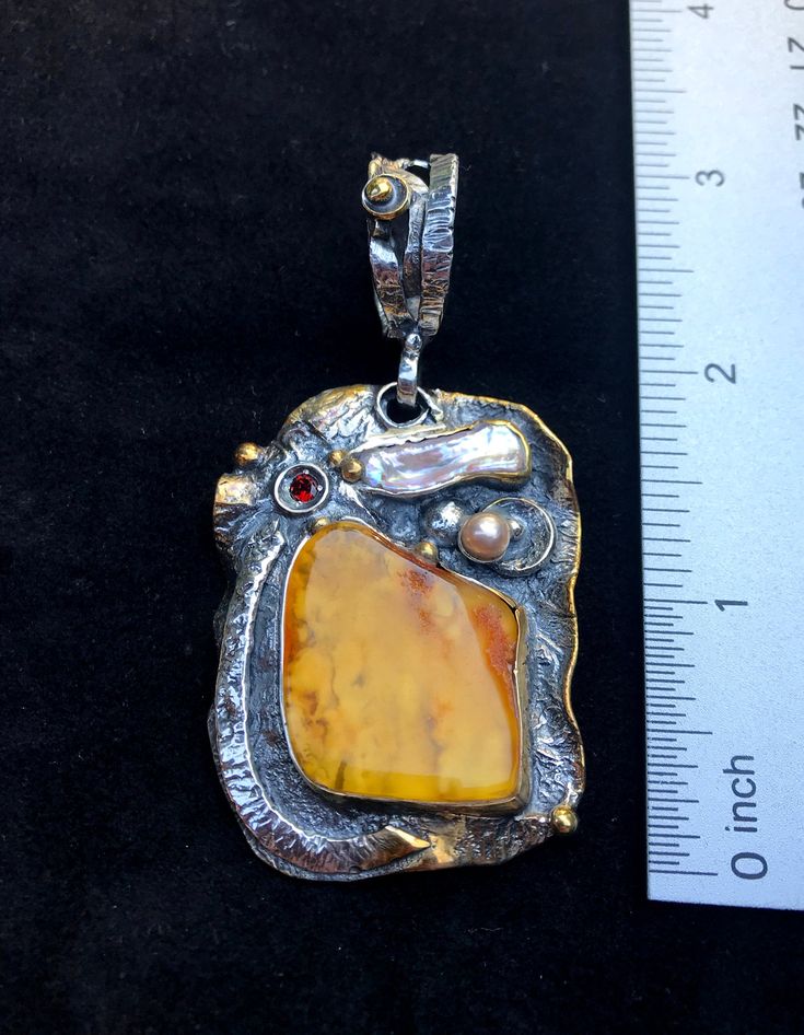 "Artisan Amber gemstone pendant Hand-made Sterling Silver 925,24k Gold Stones used: Baltic Amber, Pearls, Garnet Height - 3\" (with bail), Width - 1 1/2\" Height -75mm (with bail), Width - 38mm Unique Handcrafted One-of a-kind Design Pendant Each Piece of Jewelry in my Collection is Absolutely One of a Kind! When you start wearing a piece of my jewelry you will fall in love with it more and more each day and feel that good Energy and Love that I pass into it while creating this piece of Art. A p Unique Polished Pendant Necklace, Yellow Polished Pendant Jewelry, Artisan Pendant Jewelry With Polished Finish, Yellow Pendant Jewelry With Polished Finish, Artisan Jewelry With Polished Finish As Gift, Artisan Jewelry With Polished Finish For Gifts, Yellow Gemstone Fusion Jewelry, Yellow Fusion Gemstone Jewelry, Yellow Fusion Style Gemstone Jewelry