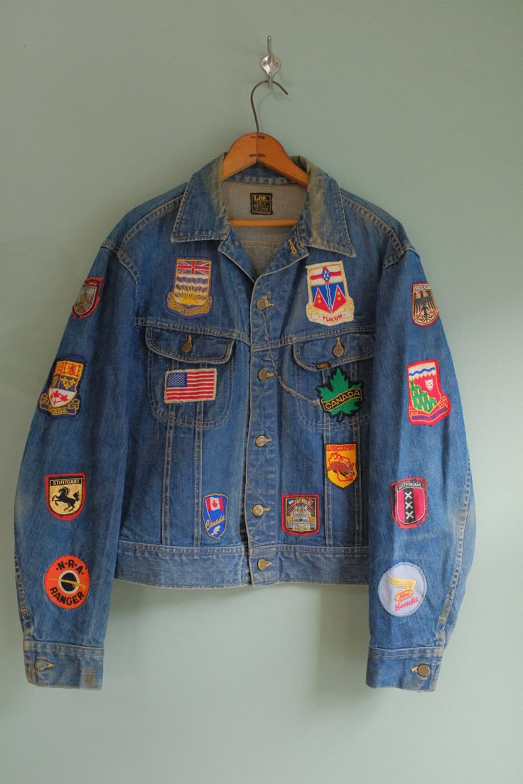 "Amazing 1970's Lee Classic 101 Riders Jacket with customized patches! This unique denim jacket features perfectly faded blue denim, brass metal button closures on the front, and plastic iconic cats eye buttons on the back of the hem. There're customized patches all over the garment from pre-loved own. Perfect to wear with white jeans or your simple casual outfit. Stunning Jacket Rare to Find!  Tag: Lee Union Made  Recommended size for M - XL, depending on how you desired fit.  Measurements  Shoulder 20\" Sleeves  24.5\" Pit to Pit  23\" Length 22.5\" There's one patch on the left side of the sleeve is a bit loose stitch but otherwise, it's a great Vintage Condition *Final Sale" Fun Jean Jacket, Denim Jacket Patches Inspiration, Denim Jacket With Patches Diy, Patches On Denim Jacket, Customized Jeans Jacket, Diy Jean Jacket Patches, Vintage Patches Jacket, Patches On Jean Jacket, Patch Jacket Ideas