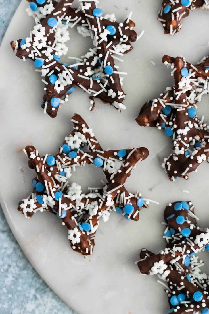 chocolate and blue sprinkles are arranged on a plate