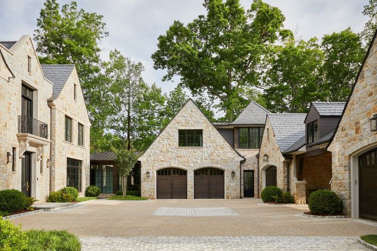 a stone house with two garages on each side