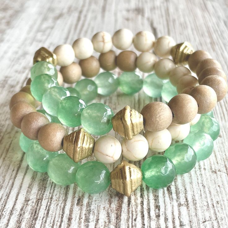 Wow, this one is a looker! The SEAFOAM stack gives off all the warm and pretty feels of the surf meeting the sand. Made with soft muted seafoam-green aventurine gemstones, creamy Calcutta style marble beads, taupe wood beads and gold accents. Buy one or buy all three to create this stunning stack! Save BIG when purchasing all three. (If purchasing one, please note bracelet preference in check out: green, cream/taupe combo or green/cream/taupe combo.)         *Made 7 inches in length for standard wrist unless a custom size is noted in checkout.  *Comes gift-giving-ready with a Salty Sunshine branded tag, sheer drawstring bag and crinkle paper. Holiday gift packing available for small fee - see separate listing.  *Free shipping on orders $35 and up! Follow Salty Sunshine Jewelry on Instagram Leather Jewelry Bracelet, Colorful Bead Bracelets, Cream Marble, Gold Bracelets Stacked, Green Beaded Bracelets, Gems Bracelet, Beaded Jewelry Designs, Beach Lover, Bohemian Bracelets