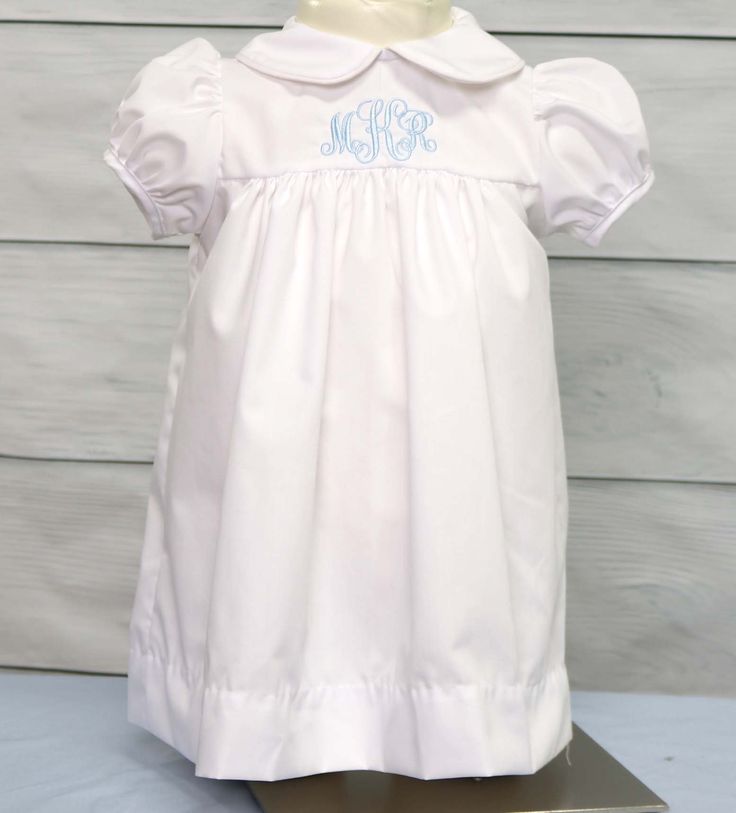 "Babygirl clothes by Zuli Kids are custom made to your specifications. Christening dress with peter pan collar is a white yoke float dress and is shown monogrammed in lilac. Other colors available. Dress is perfect for twin girl outfits or baby girl coming home outfit. *Zuli Kids Premium Quality *Peter Pan Collar with Piping *Machine Wash Gentle *Button-Back Closures *100% Cotton Fabric *Puffed Sleeves *Short or Long Sleeves *Available in Sz 12 Mo - Sz 5 *Special Classic Garment to Commemorate t Classic Short Sleeve Dress For Baptism, Fitted Bodice Short Sleeve Dress For Baptism, Classic Short Sleeve Baptism Dress With Ruffles, Classic Ruffles Baptism Dress, Classic Ruffled Baptism Dress, Classic White Baptism Dress With Fitted Bodice, White Baptism Dress With Fitted Bodice, Twin Girl Outfits, Girl Baptism Dress