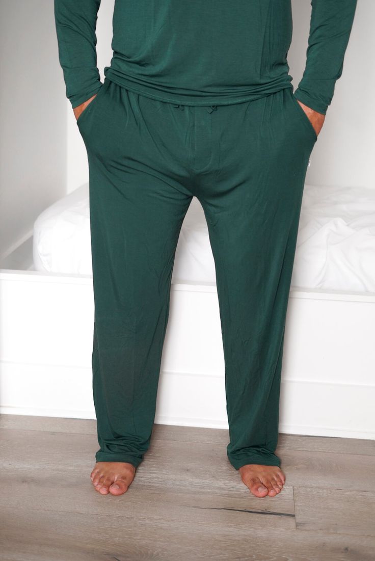 Cuddle up in comfort with these Evergreen Men's Dream Pant! These mens pajama pants are made of super soft bamboo fabric, so you'll be as snug as a bug in a rug. Plus, you can match your fam with our matching Evergreen Rib collection. Sweet dreams! Made from the softest and most breathable seasonal bamboo viscose material, you won't want to take this off! Relax, sleep and cozy up with the family in our men’s relaxed fit pants. **This listing is for the Men's Dream Pant only.** Comfortable Green Sleepwear For Home, Green Relaxed Fit Pants For Loungewear, Comfortable Green Lounge Bottoms, Comfortable Green Lounging Bottoms, Green Relaxed Fit Sleep Pants, Green Relaxed Fit Comfortable Sleepwear, Green Relaxed Fit Sleepwear With Elastic Waistband, Green Lounging Bottoms With Pockets, Comfortable Green Bottoms For Relaxation