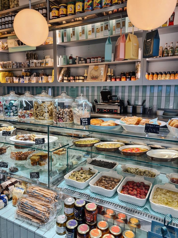 a display case filled with lots of different types of foods and condiments on top of glass shelves