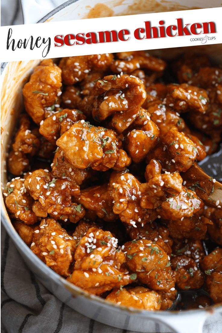 honey sesame chicken in a white bowl with a spoon and the words honey sesame chicken above it