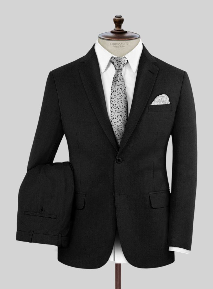 Imbibe the essence of sophistication and refined style with our premium Marco Stretch Deep Black Wool Suit, symbolizing your status as a tasteful connoisseur. Crafted from a luxurious wool blend, this timeless piece boasts a striking solid pattern in a black hue. The fabric's stretch ensures not only comfort but also recognizes the modern man's need for flexibility in a rapidly changing world. Whether conquering the corporate landscape or marking life's milestones, this suit guarantees that you Black Wool Fabric, Harris Tweed Jacket, Herringbone Jacket, Oxford Blue, Tweed Suits, Linen Suit, Wide Stripes, Refined Style, Patches Jacket