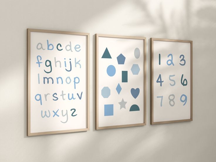 three framed art pieces on the wall with numbers and shapes in blue, grey and white