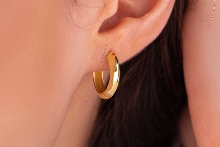 Our asymmetrical hoop earring is 14k solid gold. It has an absolutely unique style that everyone loves it!  It will accompany you at any time of the day. This gold dome hoop earring completes your all outfit in a day. The lock part of the huggie earring is very useful, the most important feature of a lock system is that the lock part is positioned inside the earring in a way that does not disturb you at all. If you wish you can buy it with the gold asymmetrical ring as a set. https://www.etsy.co Modern Single 14k Gold Hoop Earring, Modern 14k Gold Filled Pierced Hoop Earrings, Modern 14k Gold-filled Pierced Hoop Earrings, Asymmetrical Ring, Rib Ring, Earring Minimalist, Minimalist Earring, Huggie Earring, Solid Gold Rings