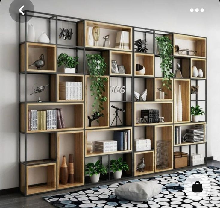 a living room filled with lots of bookshelves next to a black and white rug