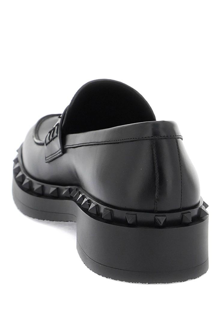 Valentino Garavani's Rockstud M-Way loafers are crafted in smooth leather and adorned with a rubber tone-on-tone studded trim. The lining and insole are made of leather, while the sole features embossed studs. These stylish loafers are perfect for adding a touch of edginess to any outfit. Studded Loafers, Leather Cap, Mens Gloves, Beach Tote Bags, Sneaker Heels, Lanvin, Pump Shoes, Shoulder Handbags, Mens Shoes Sneakers