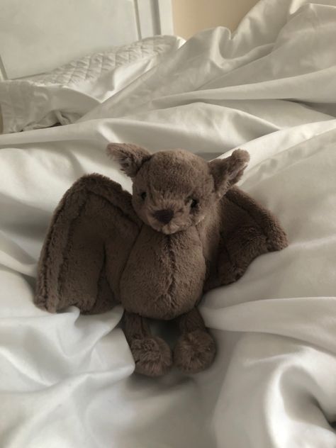 a stuffed animal sitting on top of a bed