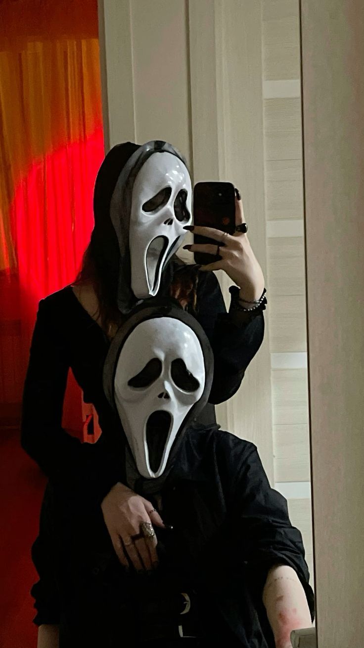 two people with masks on taking a selfie