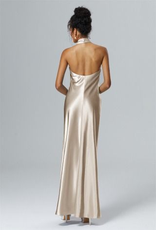 the back of a woman in a gold dress with her back turned to the camera