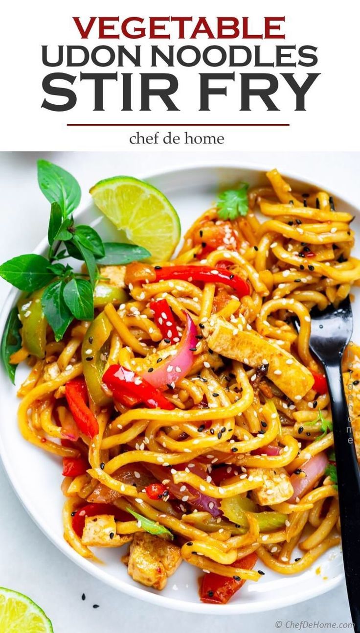 a plate full of stir fry noodles with vegetables and sauce on top, next to a fork