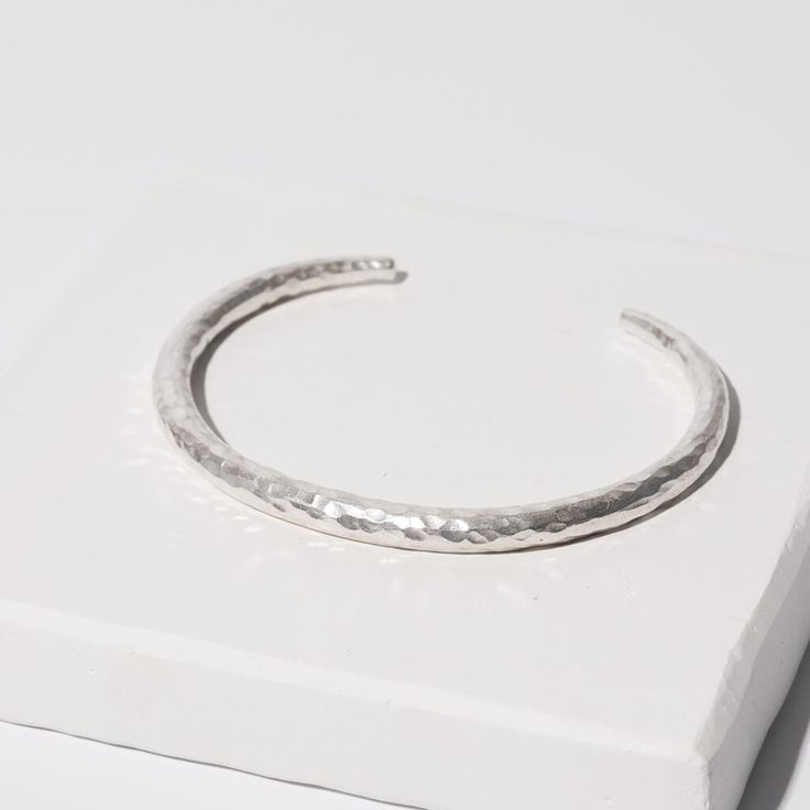 Made with 100% Brass and 100% Sterling Silver One size 2.75"D 0.25" Band Width at its widest point Handcrafted in Nepal This cuff bangle wraps your wrist elegantly. Wear alone or layered with other bracelets to create your own look. A true statement piece that is finished with a hammering technique that makes each piece completely unique. *Made entirely by hand, slight variations make each piece truly one of a kind Care: Metals will tarnish as they respond to moisture and individual body chemist Gift Double Band Cuff Bracelet, Modern Hammered Bangle Bracelets, Adjustable Sterling Silver Cuff Bracelet, Adjustable Stackable Cuff Bracelet, Adjustable Hammered Cuff Bangle, Adjustable Hammered Cuff Bracelet, Modern Hammered Cuff Bangle, Modern Stackable Adjustable Cuff Bracelet, Modern Adjustable Stackable Cuff Bracelet