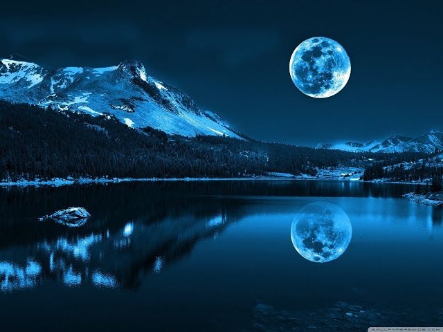 the full moon is reflected in the water