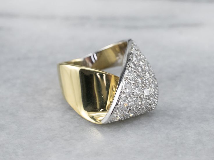 The simple wrap design of this ring is what saves it from being over the top, and keeps it the classy, sophisticated piece that it is. Rows of fine, bright, sparkling diamonds sit flush to the mounting, a perfect anniversary or cocktail piece!Metal: 18K Yellow and White GoldGem: 40 Diamonds totaling 2.15 Carats, SI1 in Clarity, H in ColorGem Measurements: 3.3 mm, RoundRing Size: 4.50Marks: "18K" Stamped on the inside band Formal Fine Jewelry Diamond Ring With Tension Setting, Classic Wide Band Ring With Tension Setting For Anniversary, Formal Tension Setting Diamond Ring, Classic Brilliant Cut Wide Band Ring For Wedding, Elegant Wide Band Ring For Formal Occasions, Classic Wide Band Wedding Ring With Brilliant Cut, Classic Wedding Ring With Brilliant Cut, Modern Diamond White Bypass Ring For Anniversary, Elegant Pave Setting Bypass Ring For Anniversary