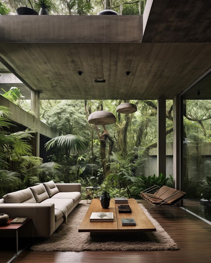 a living room filled with furniture and lots of trees in the background on top of a wooden floor