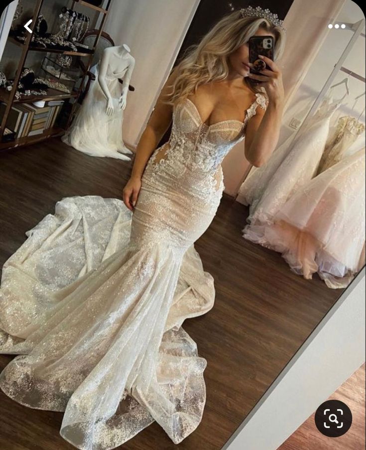 a woman taking a selfie in her wedding dress