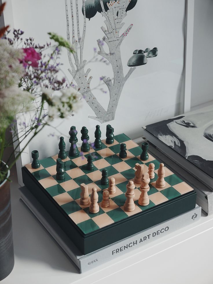 a chess board and some flowers on a table